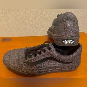 A limited edition Vans. All black covered in multi colored GLITTER print